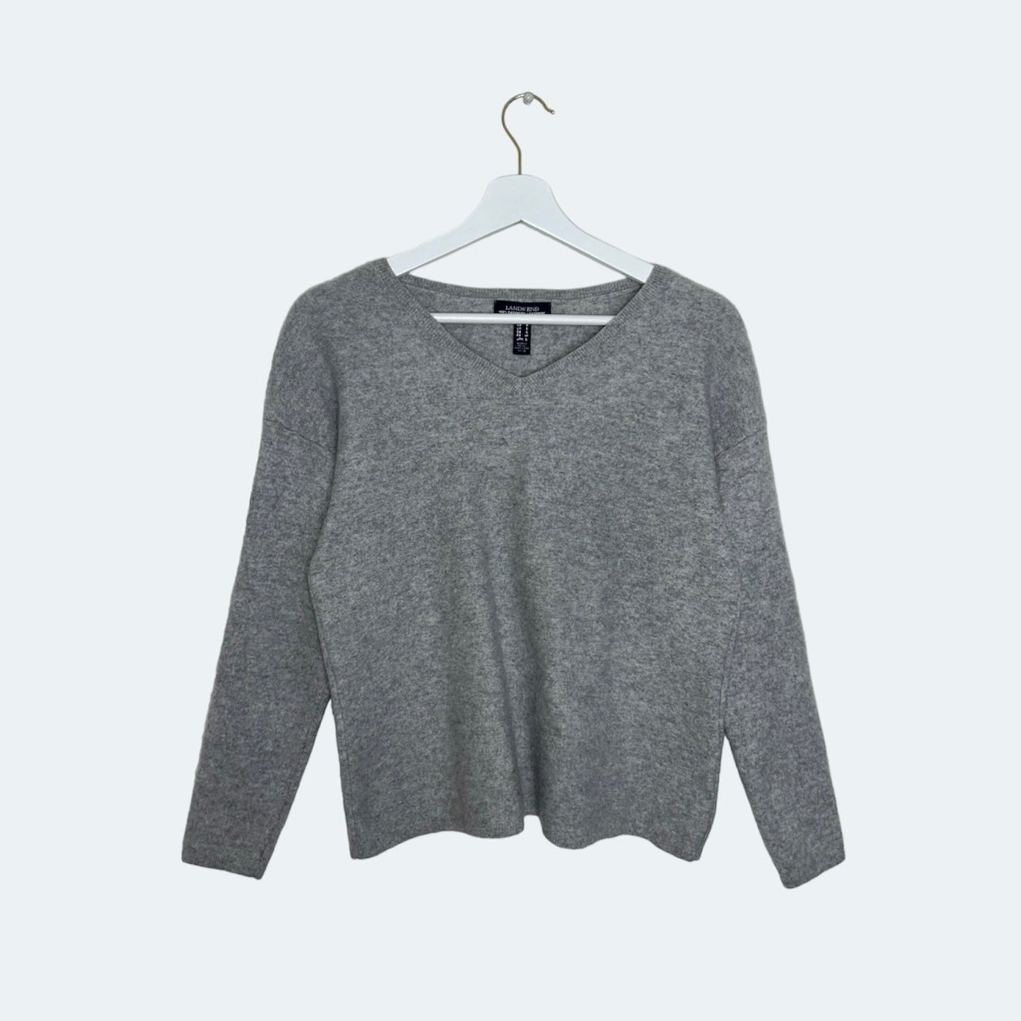 grey knit jumper shown on a white background