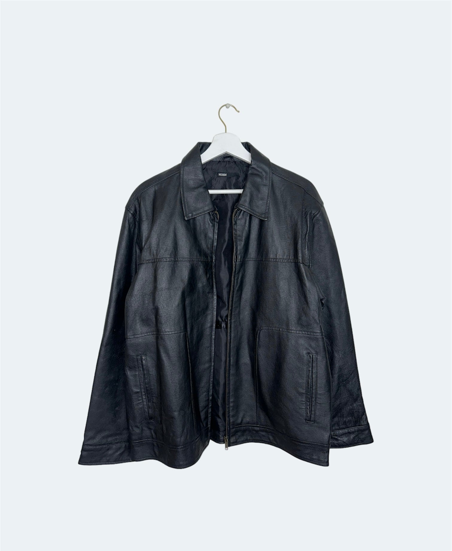 front offront of  black leather vintage bomber jacket 