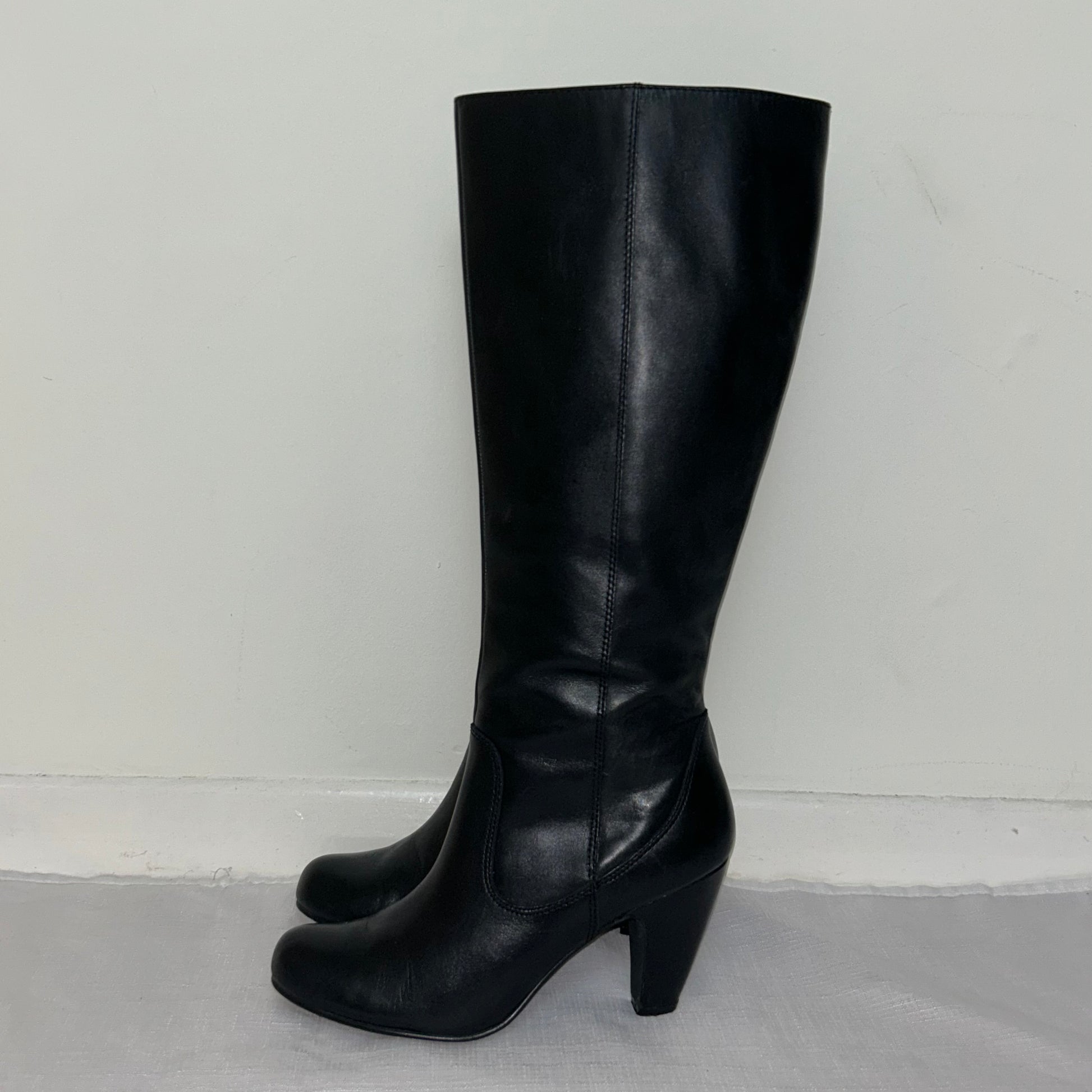 black knee high real leather boots on a white background