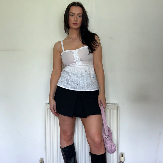 white linen vintage cami top shown on a model wearing a black mini skirt and black boots
