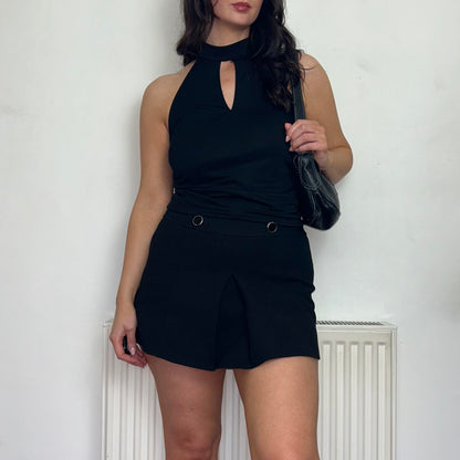 black halterneck vintage top  shown on a model wearing a black mini skirt and black bag