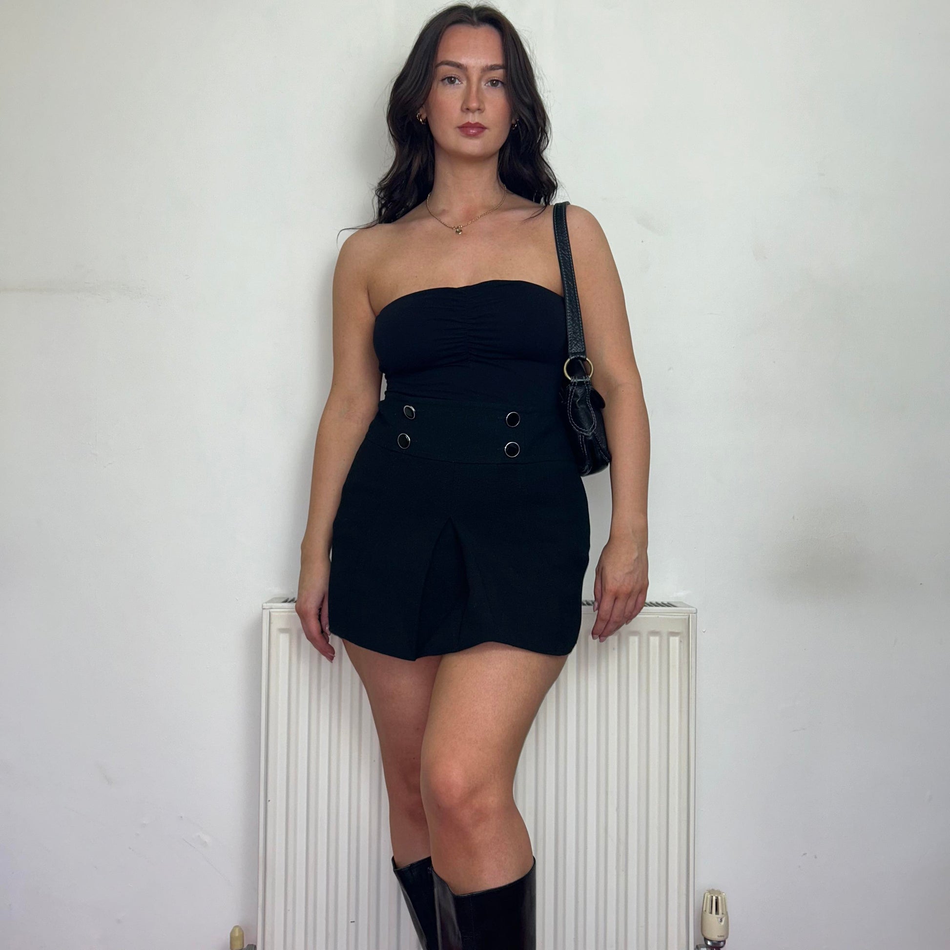 black vintage bandeau top shown on a model wearing a black mini skirt with black boots