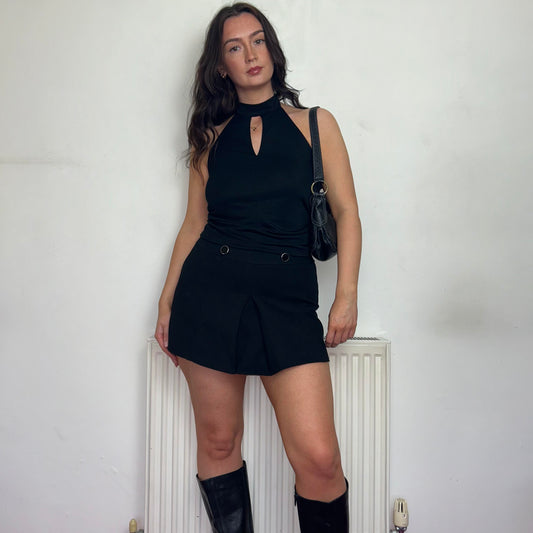 black halterneck vintage top  shown on a model wearing a black mini skirt