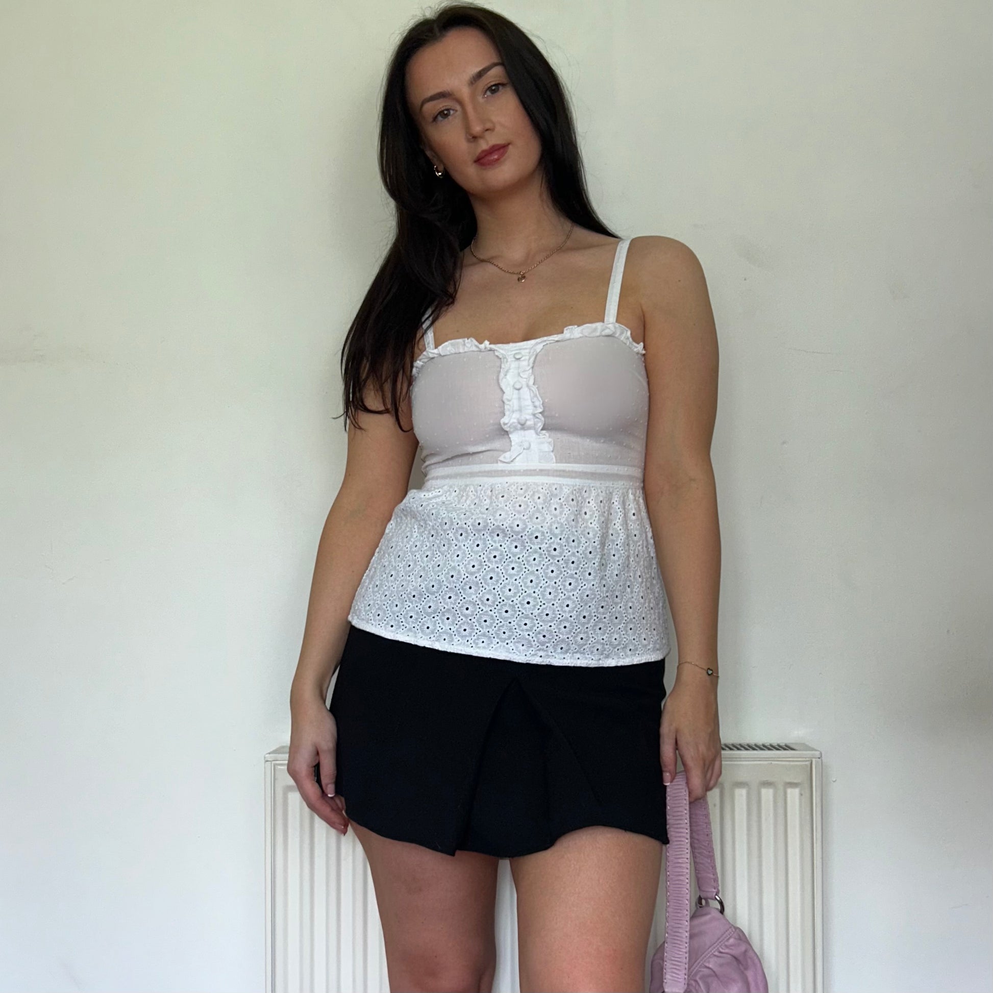 white linen vintage cami top shown on a model wearing a black mini skirt