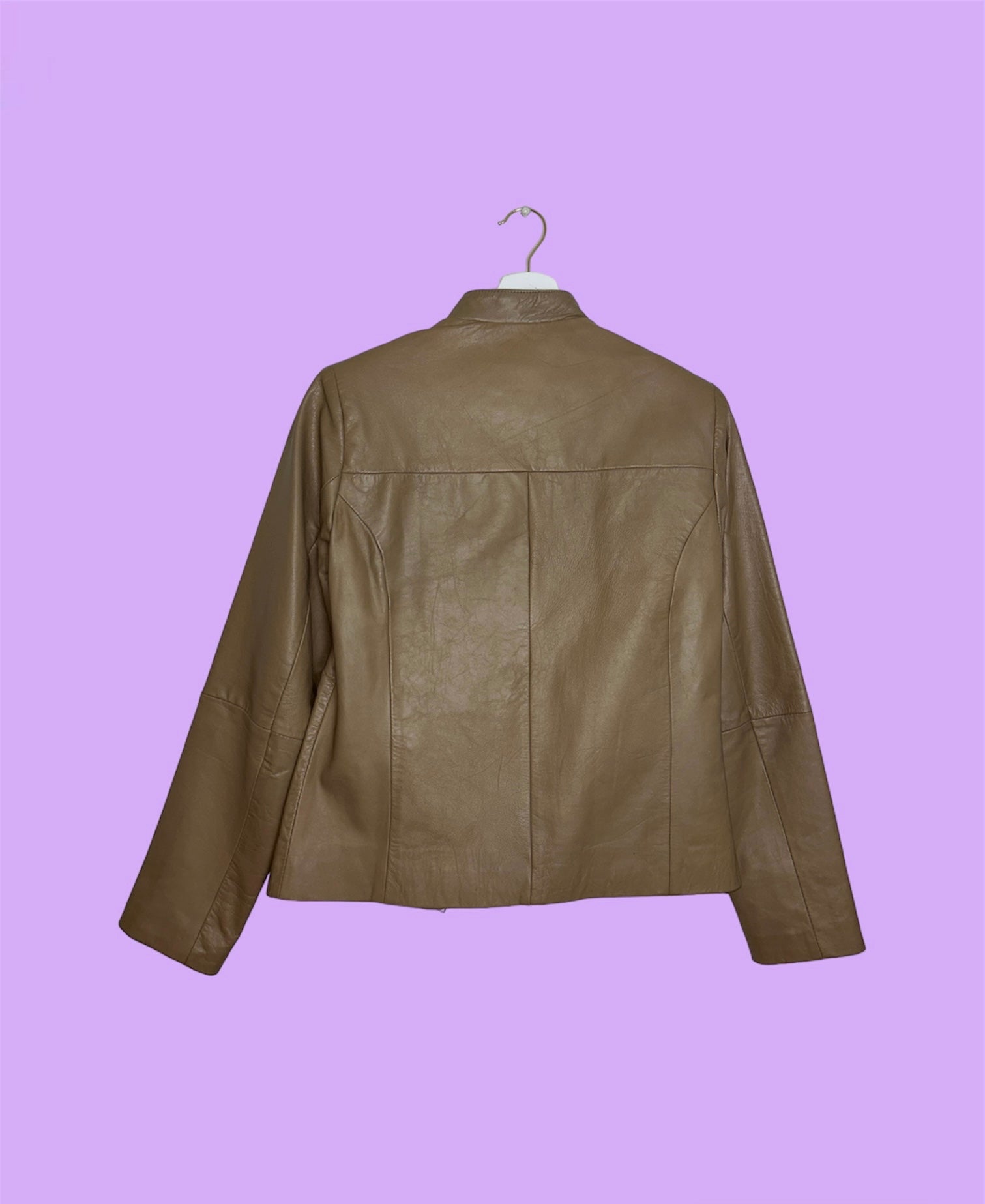 back of tan beige real leather jacket shown on a lilac background