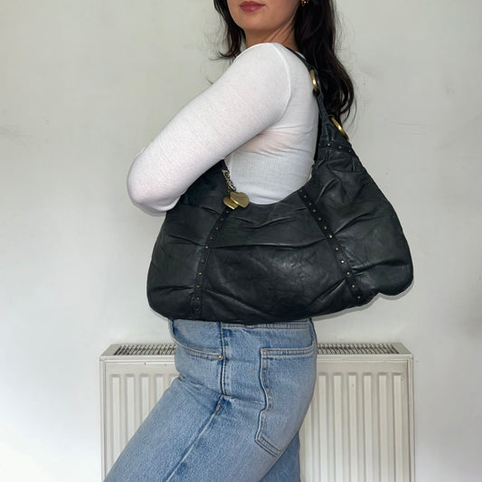 black leather slouchy vintage bag shown on a models shoulder