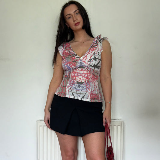 white and pink vintage top shown on a model wearing a black mini skirt