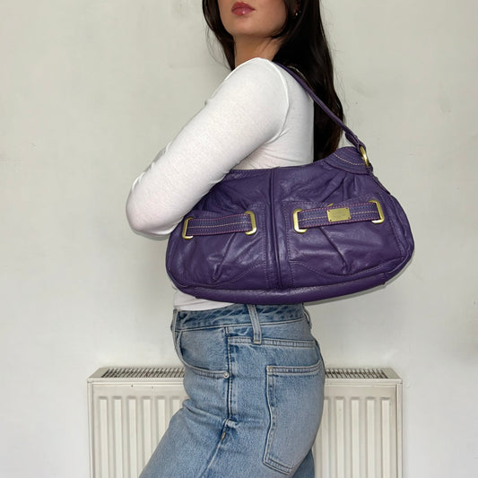 purple vintage leather shoulder bag shown on a models shoulder