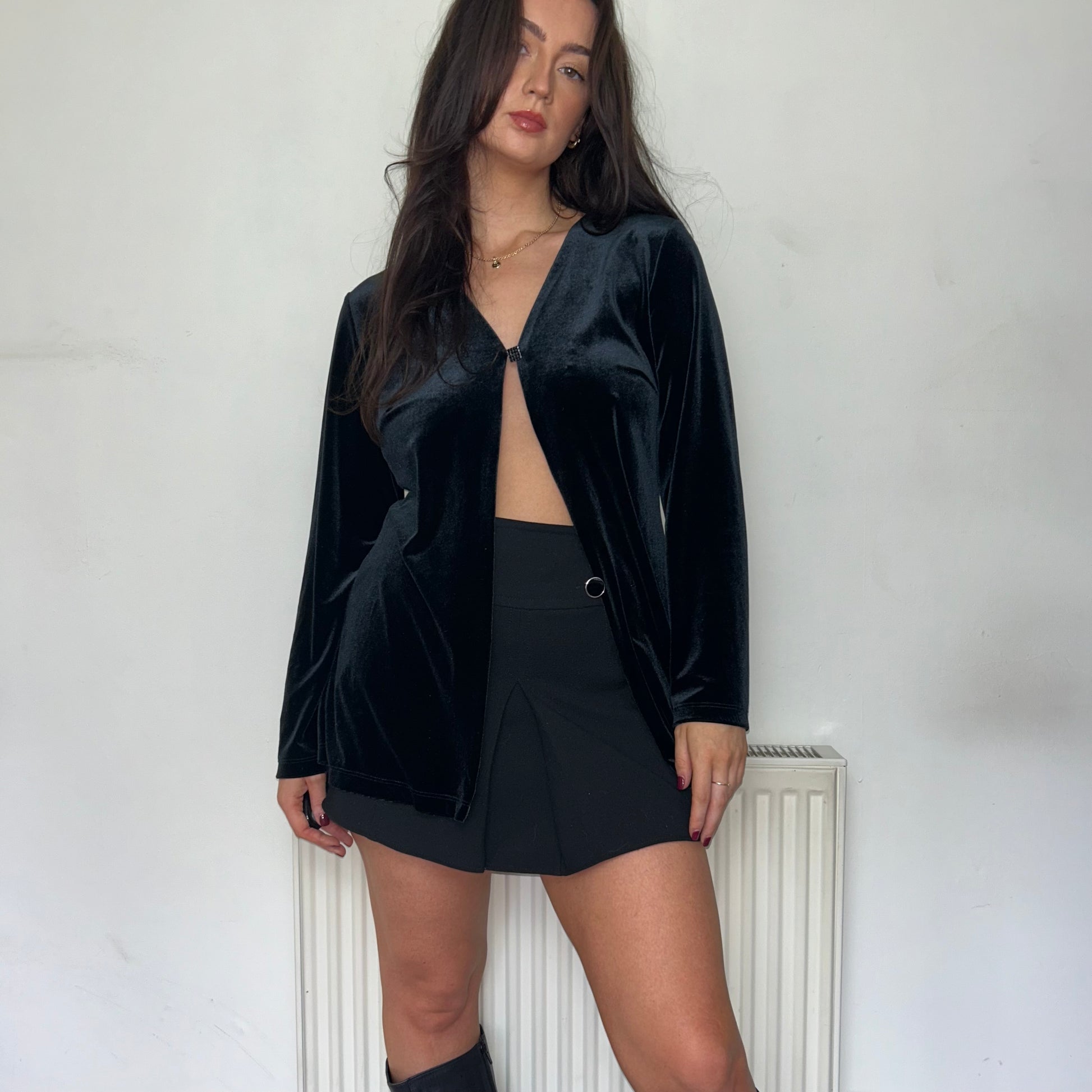 black long sleeve velvet top shown on a model wearing a black skirts and black boots