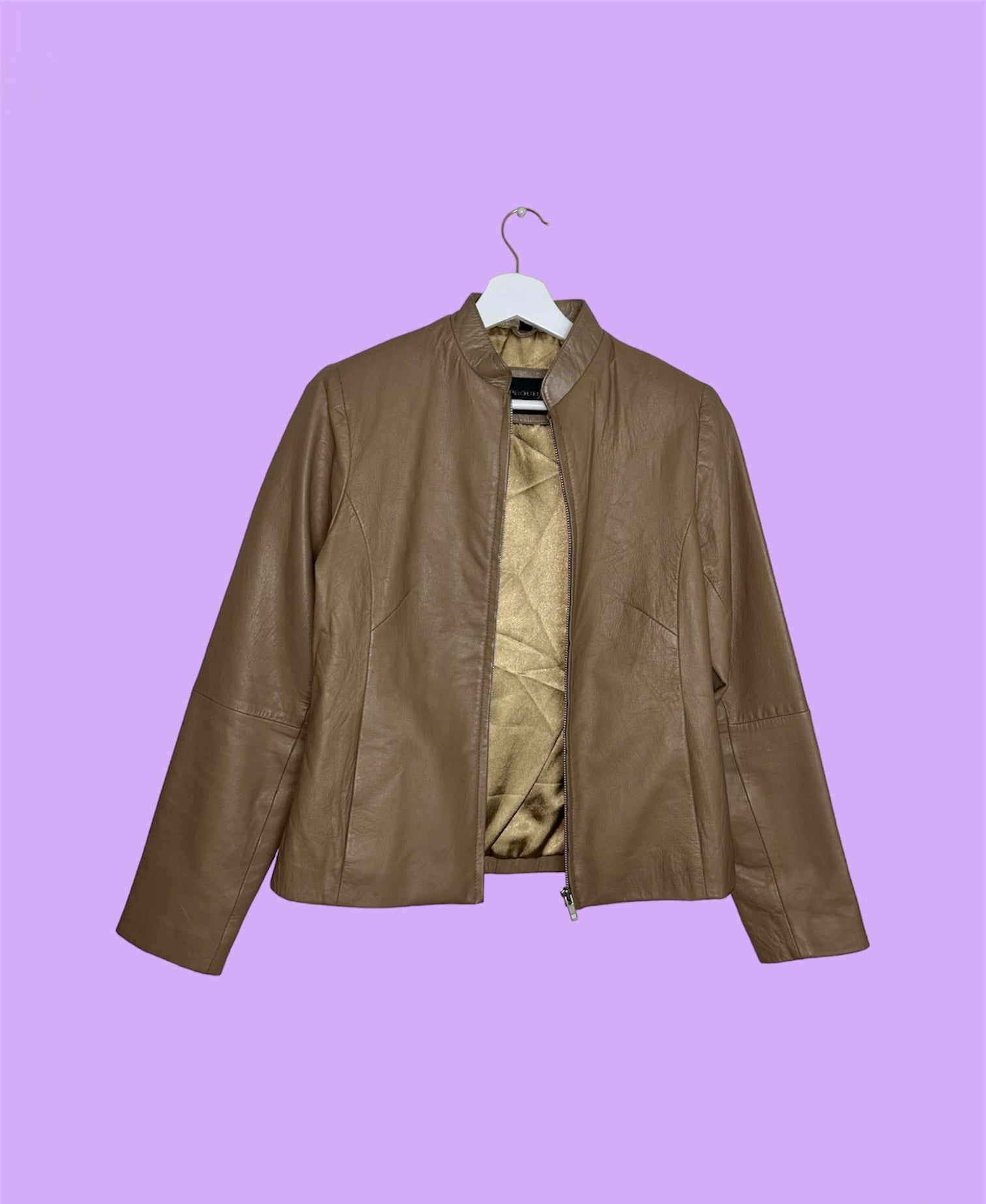 tan beige real leather jacket shown on a lilac background
