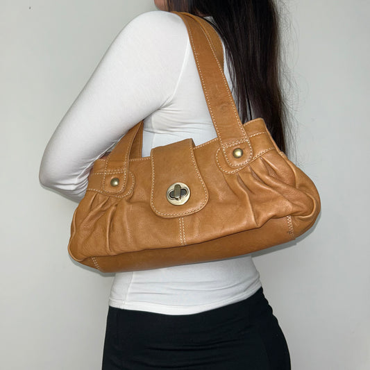 tan brown leather shoulder bag shown on a model