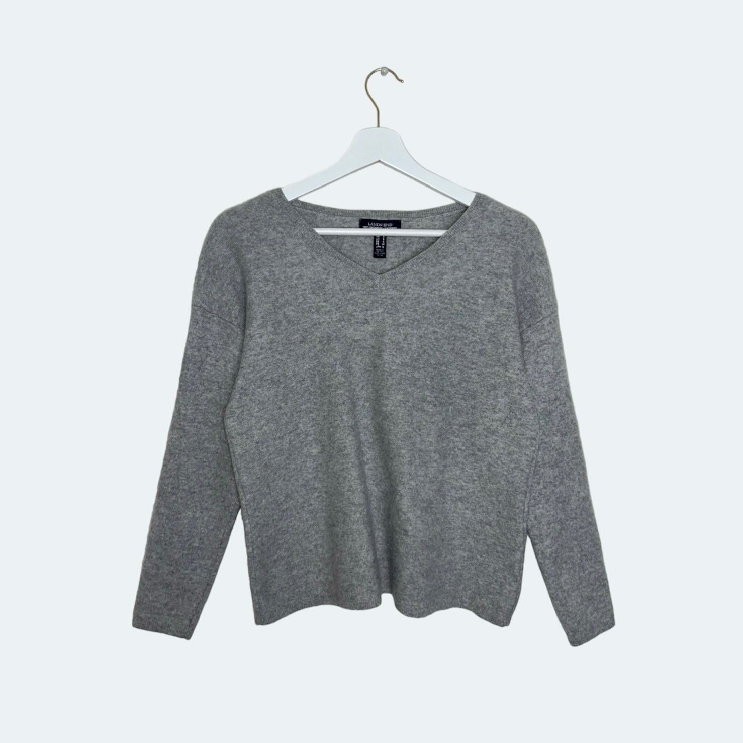 grey knit jumper shown on a white background