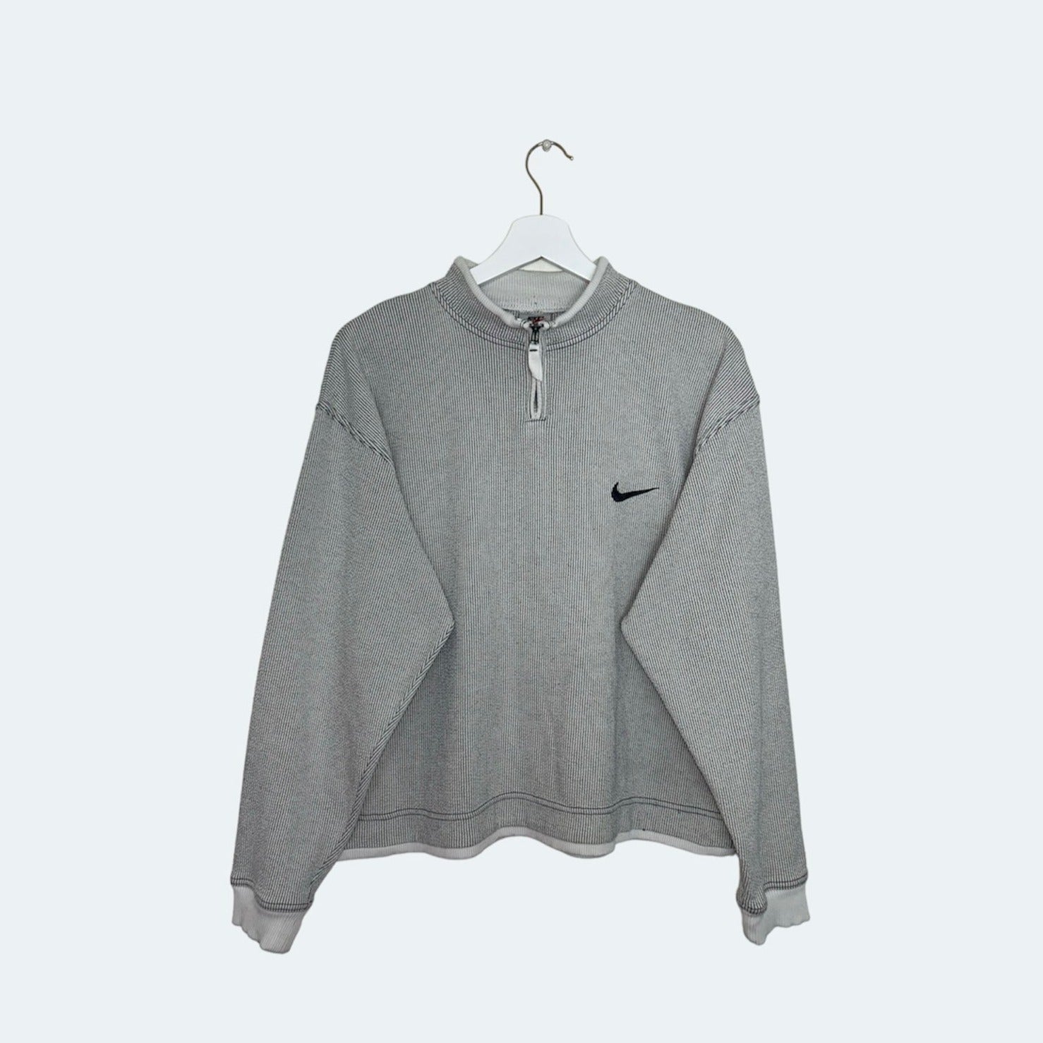 front of grey nike stripe 1/4 zip jumper shown on a white background