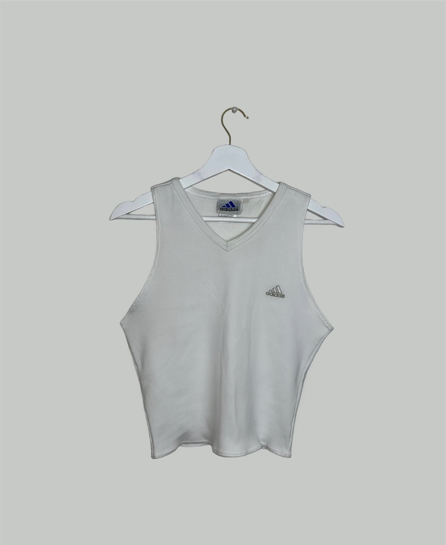 white sleeveless crop top with grey adidas logo