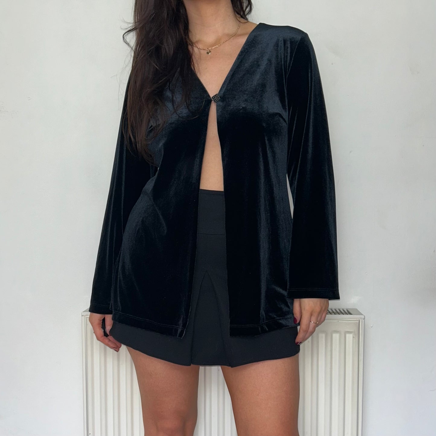 black long sleeve velvet top shown on a model wearing a black skirts and black boots