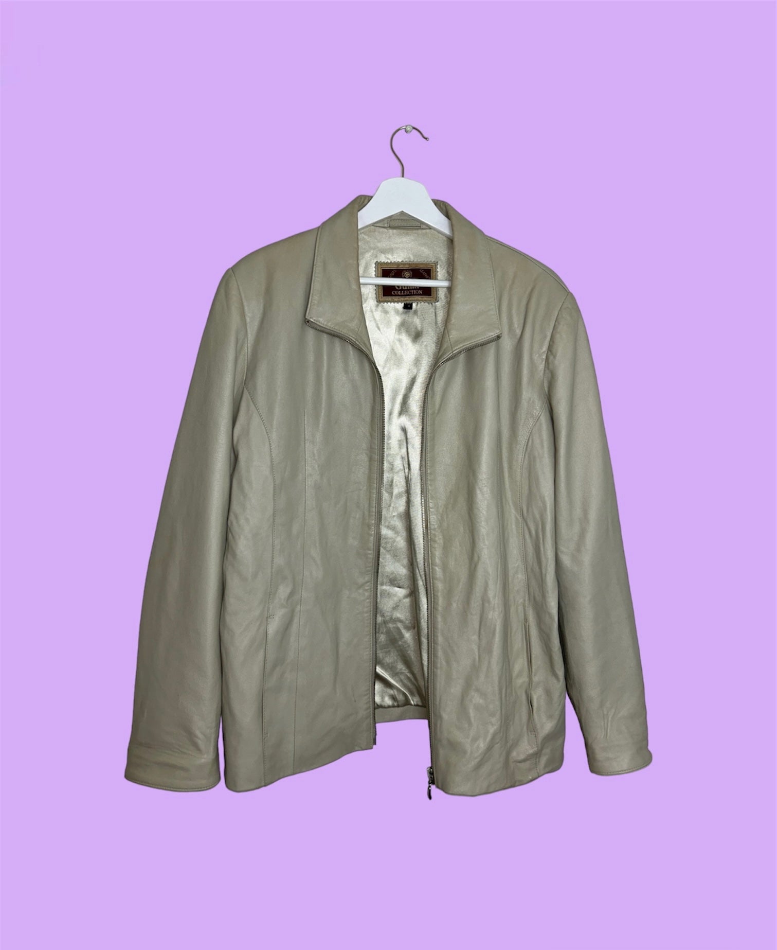beige leather zip up jacket shown on a lilac background