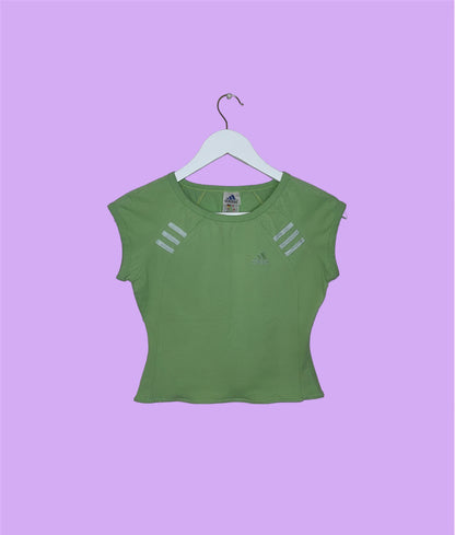 light green short sleeve crop top with white adidas logo shown on a lilac background