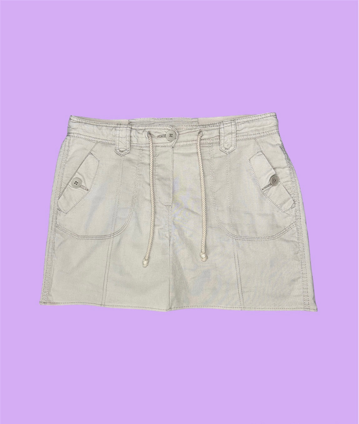 beige cargo mini skirt shown on a lilac background