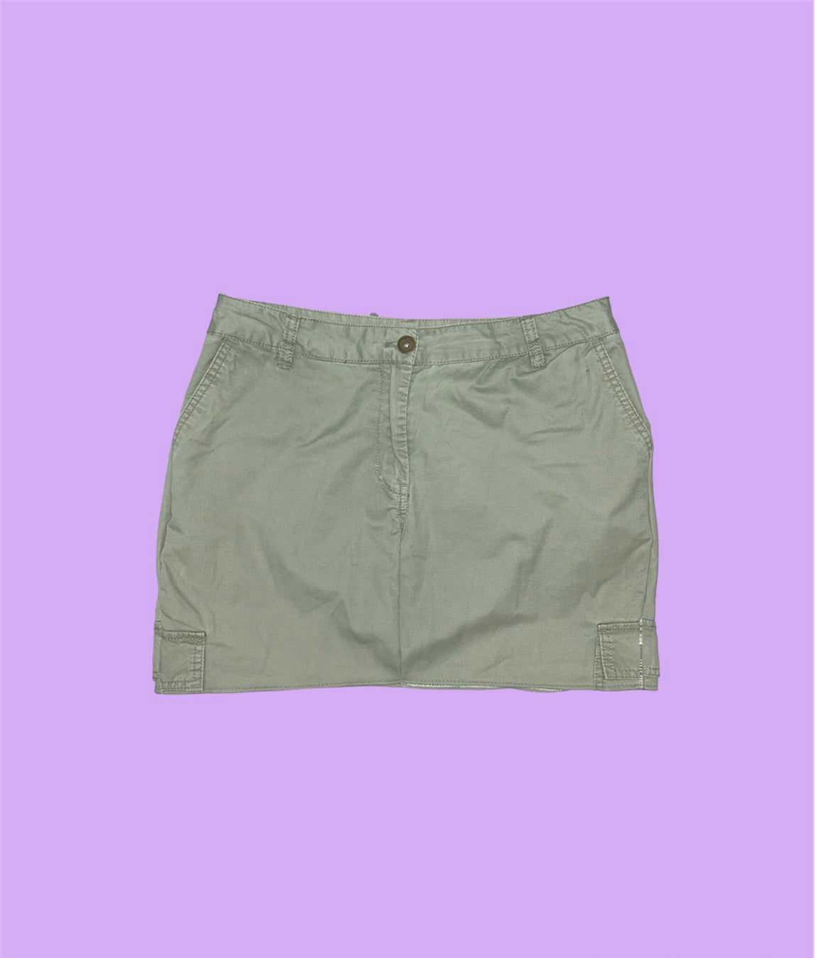 light green cargo mini skirt shown on a lilac background