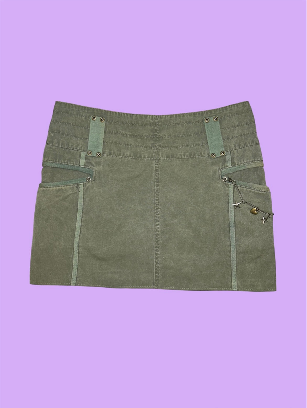 back of khaki mini cargo skirt shown on a lilac background