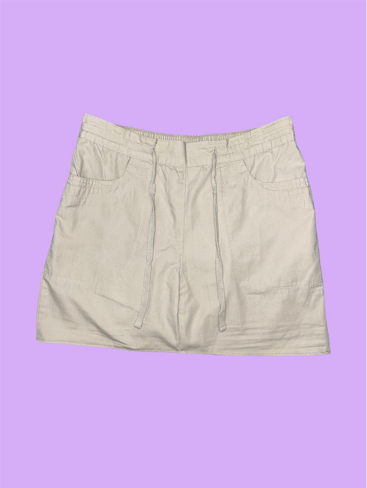 beige mini cargo skirt shown on a lilac background