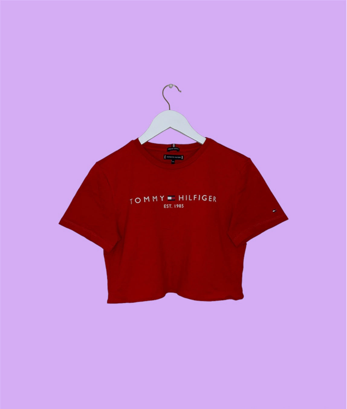 red short sleeve crop top with white tommy hilfiger logo shown on a lilac background