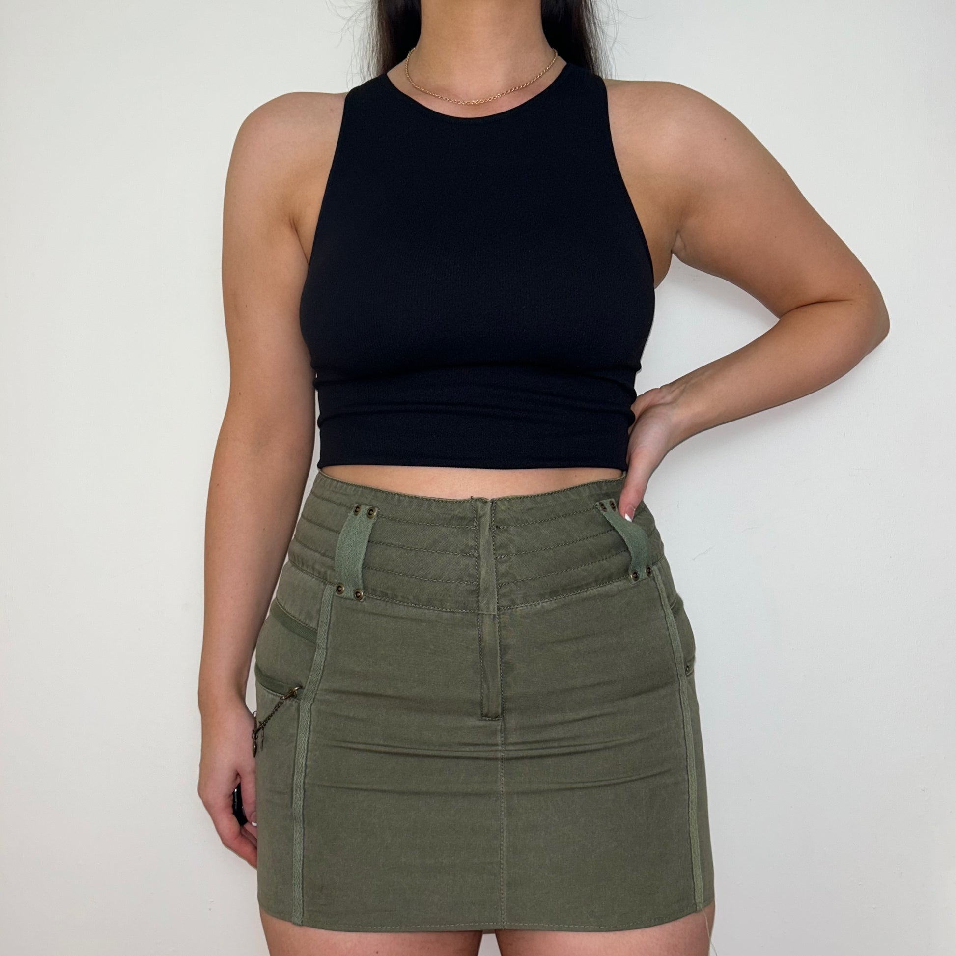khaki mini cargo skirt shown on a model wearing a black sleeveless crop top