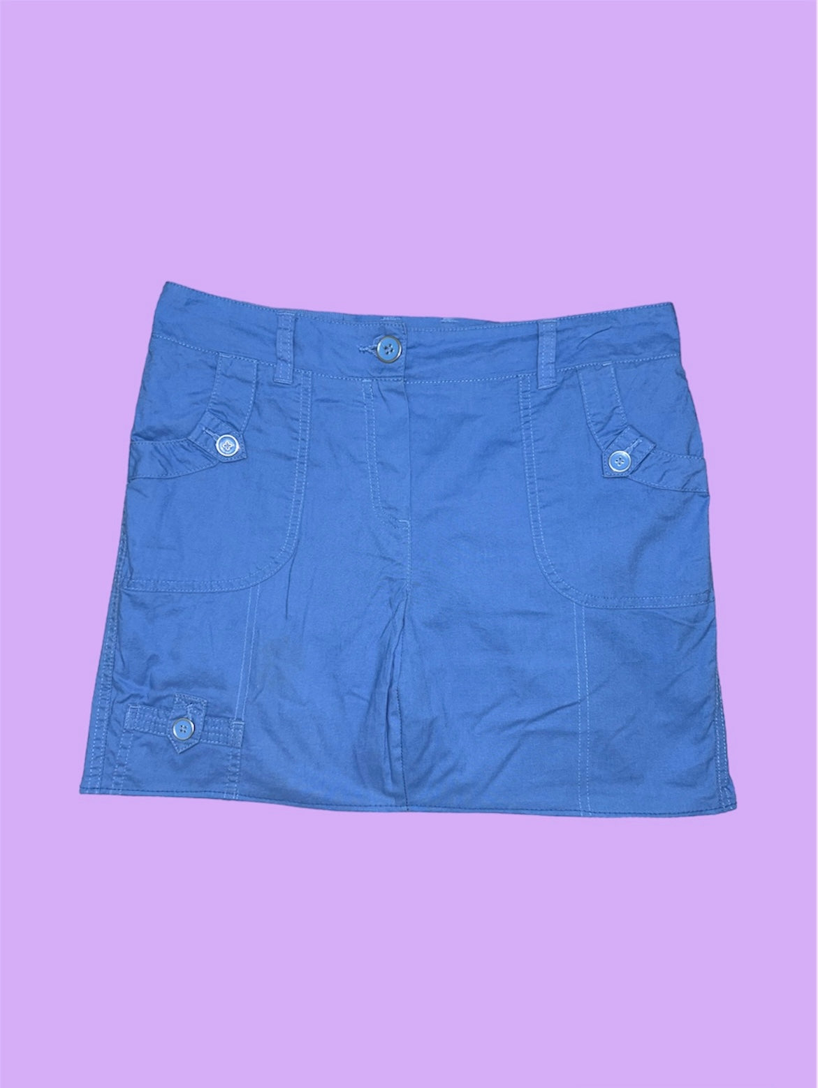 blue mini cargo skirt shown on a lilac background