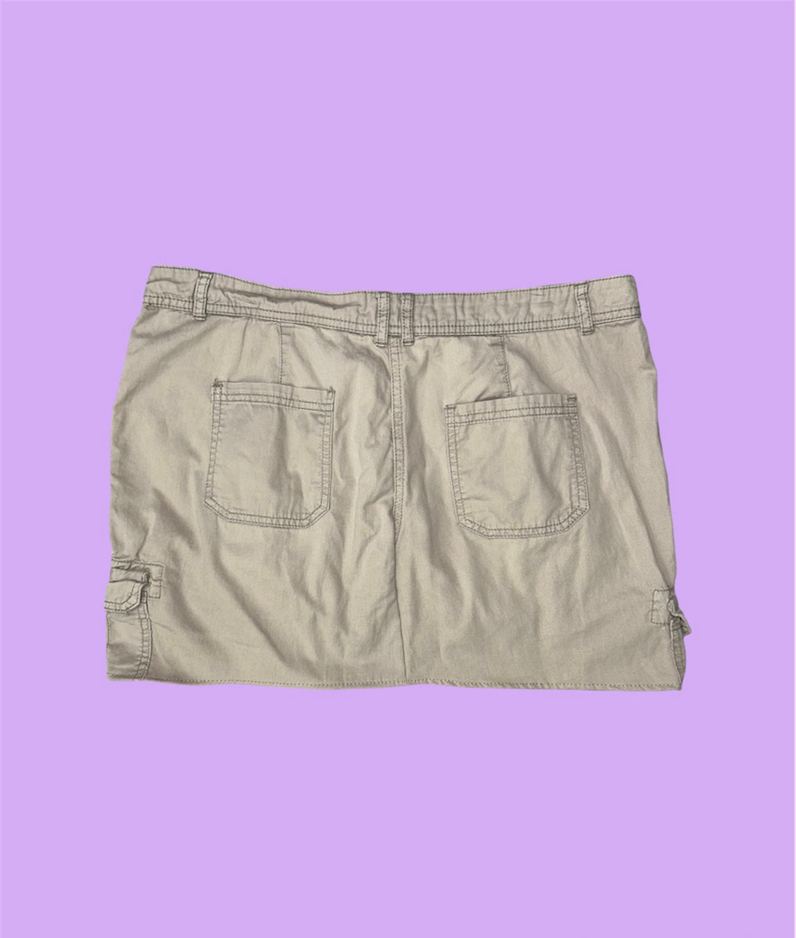 back of beige cargo mini skirt shown on a lilac background