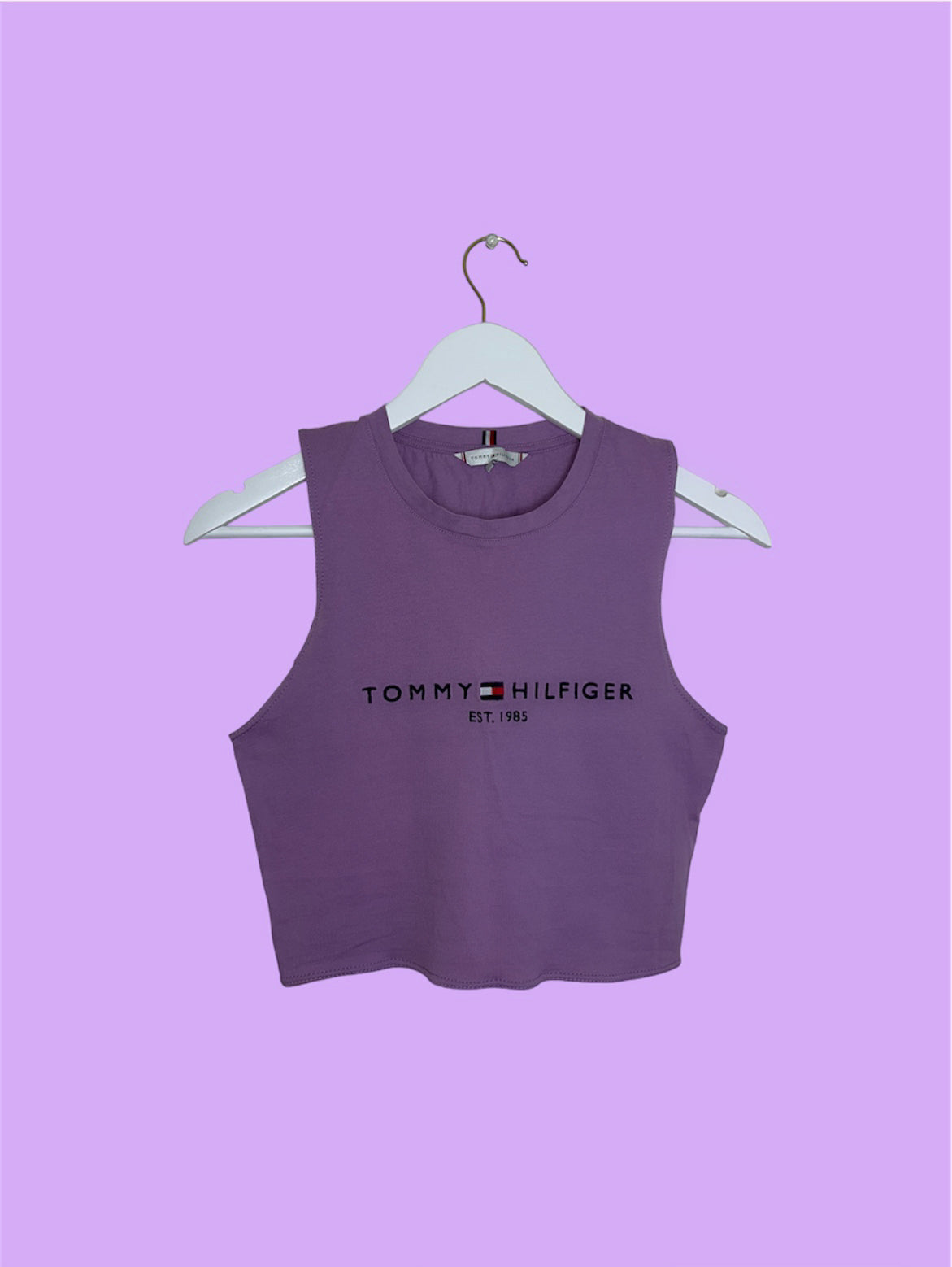 lilac sleeveless crop top with black tommy hilfiger logo shown on a lilac background