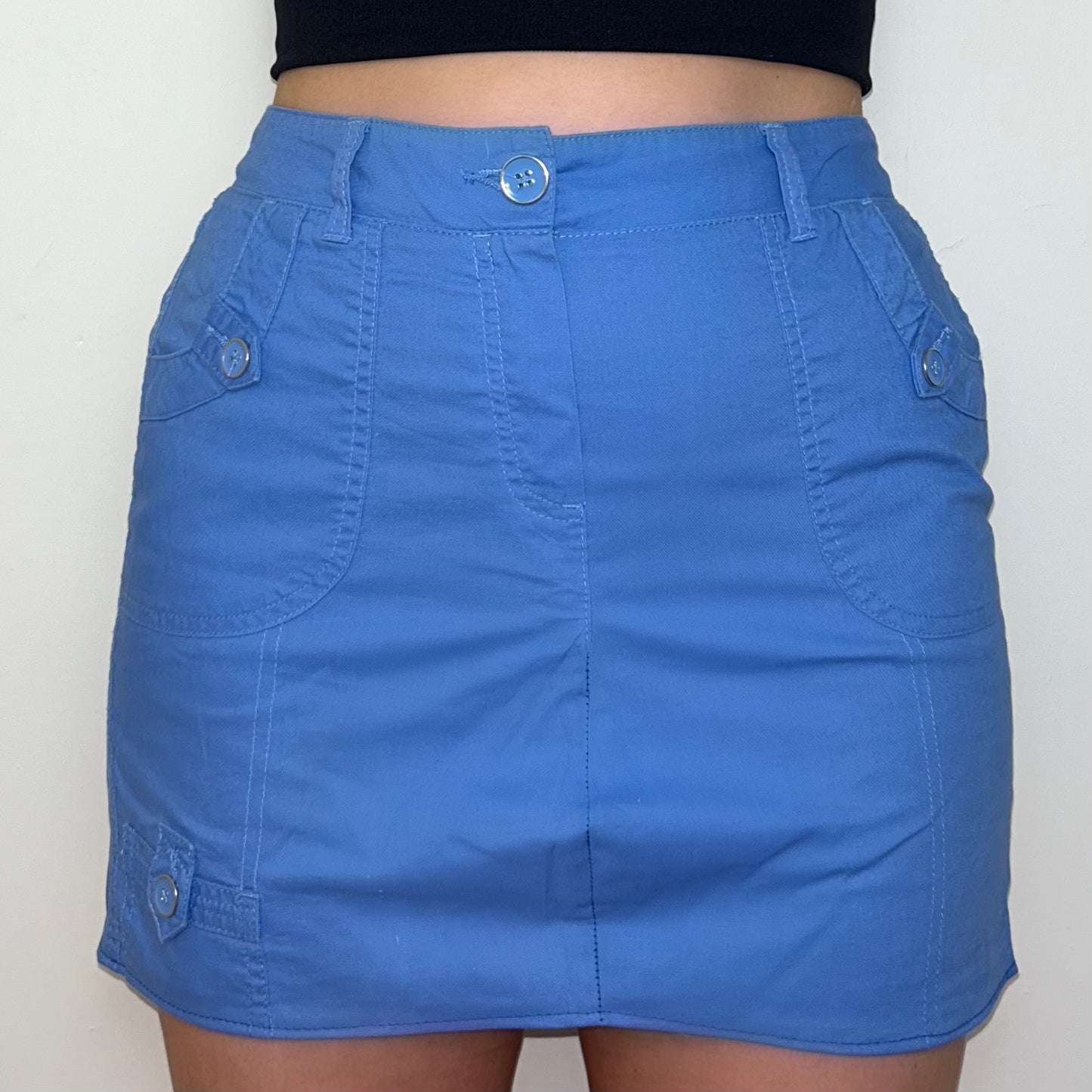 close up of blue mini cargo skirt shown on a model