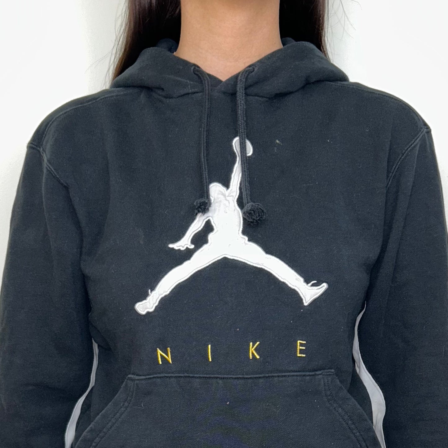 close up of black hoodie with nike jordan logo shown on a model