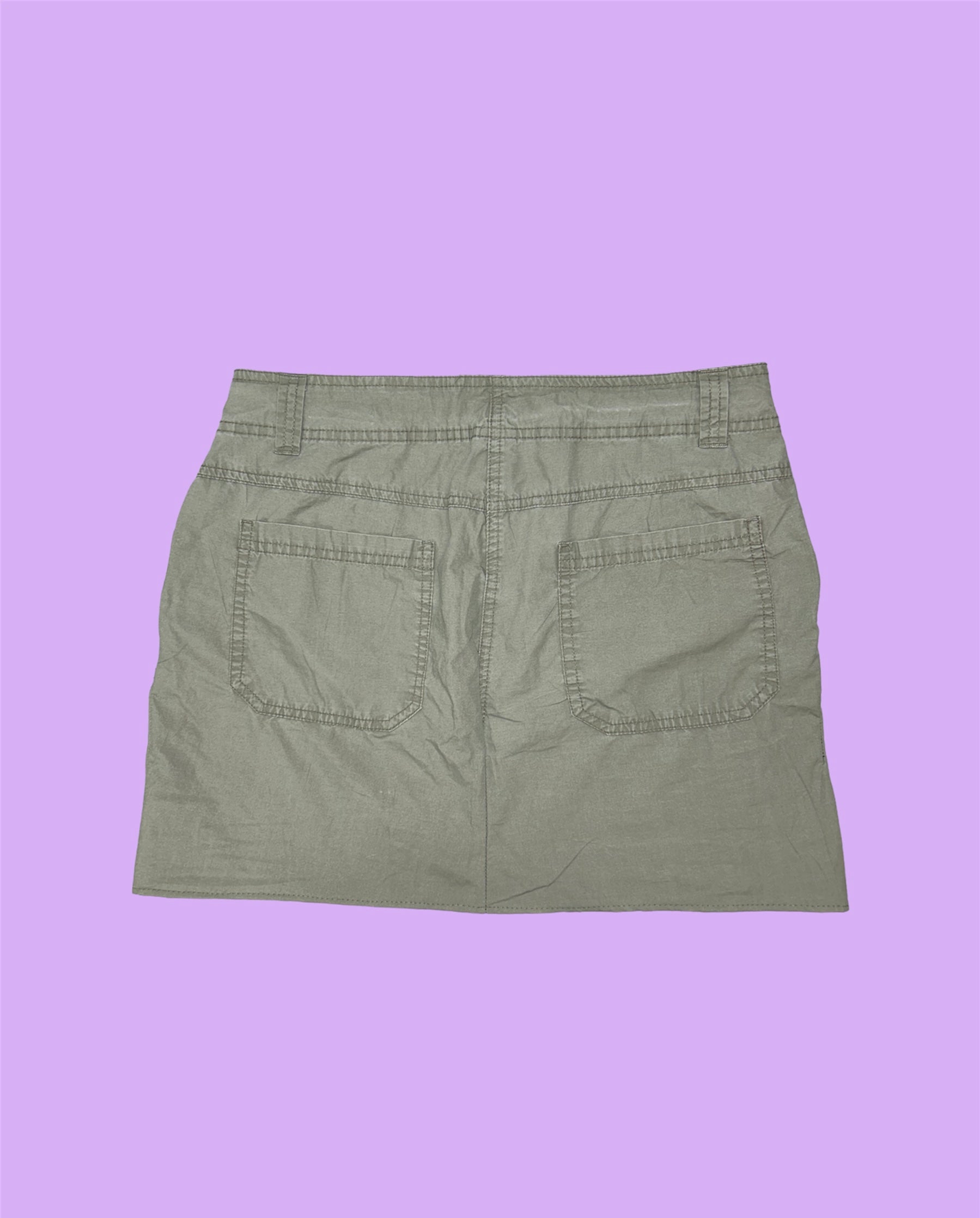 back of a khaki grey mini cargo skirt shown on a lilac background