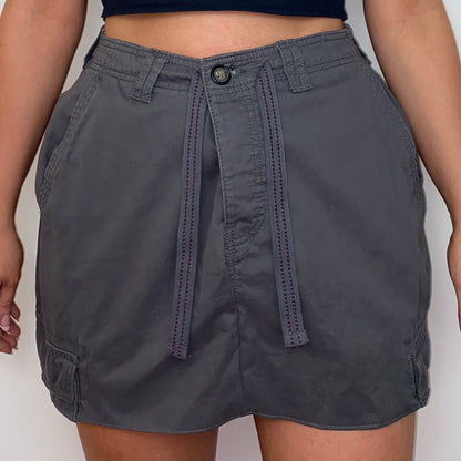 close up of a grey mini cargo skirt shown on a model