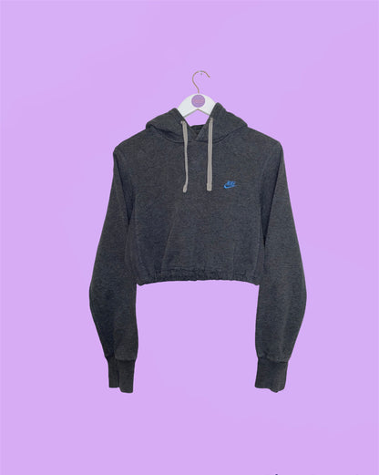 grey cropped hoodie white blue small nike logo shown on a white clothes hanger on a lilac background