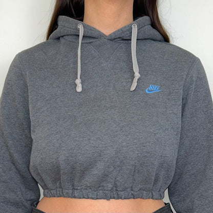 close up of dark grey cropped hoodie with small blue nike logo shown on a model