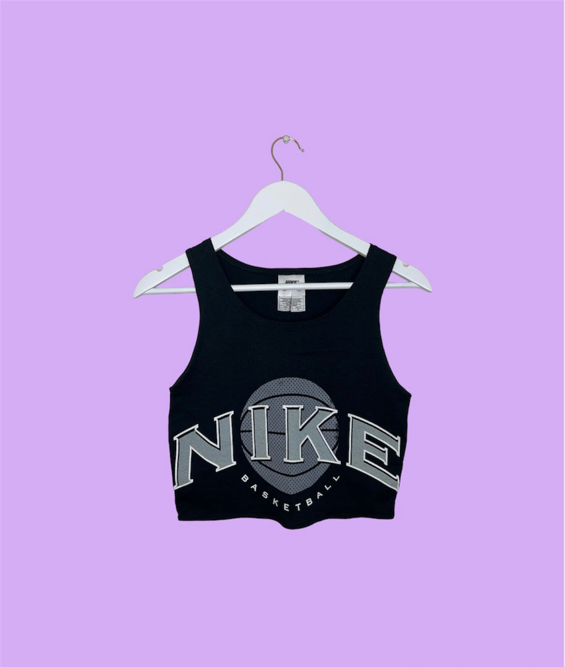black sleeveless crop top with grey nike logo shown on a lilac background