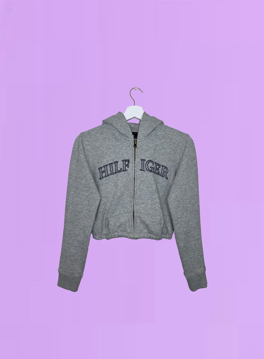 grey 1/4 zip cropped hoodie with navy hilfiger logo shown on a lilac background