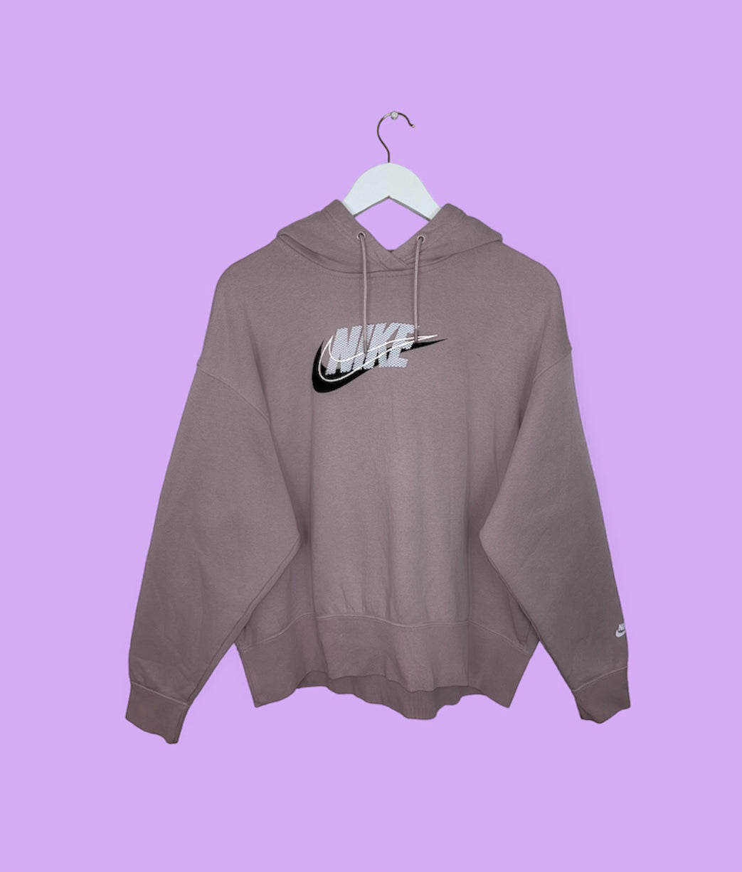 pink hoodie with white and black nike logo shown on a lilac background