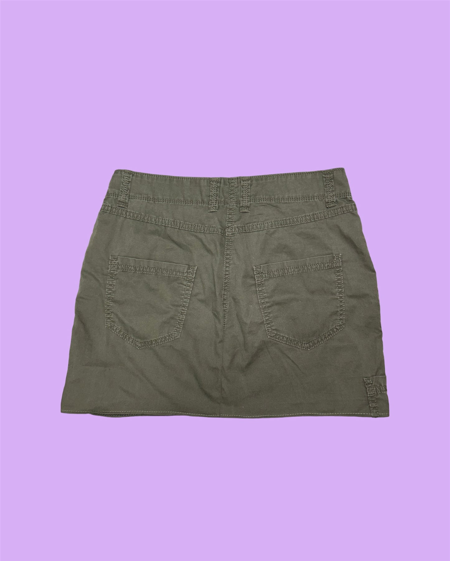 back of khaki brown cargo mini skirt shown on a lilac background