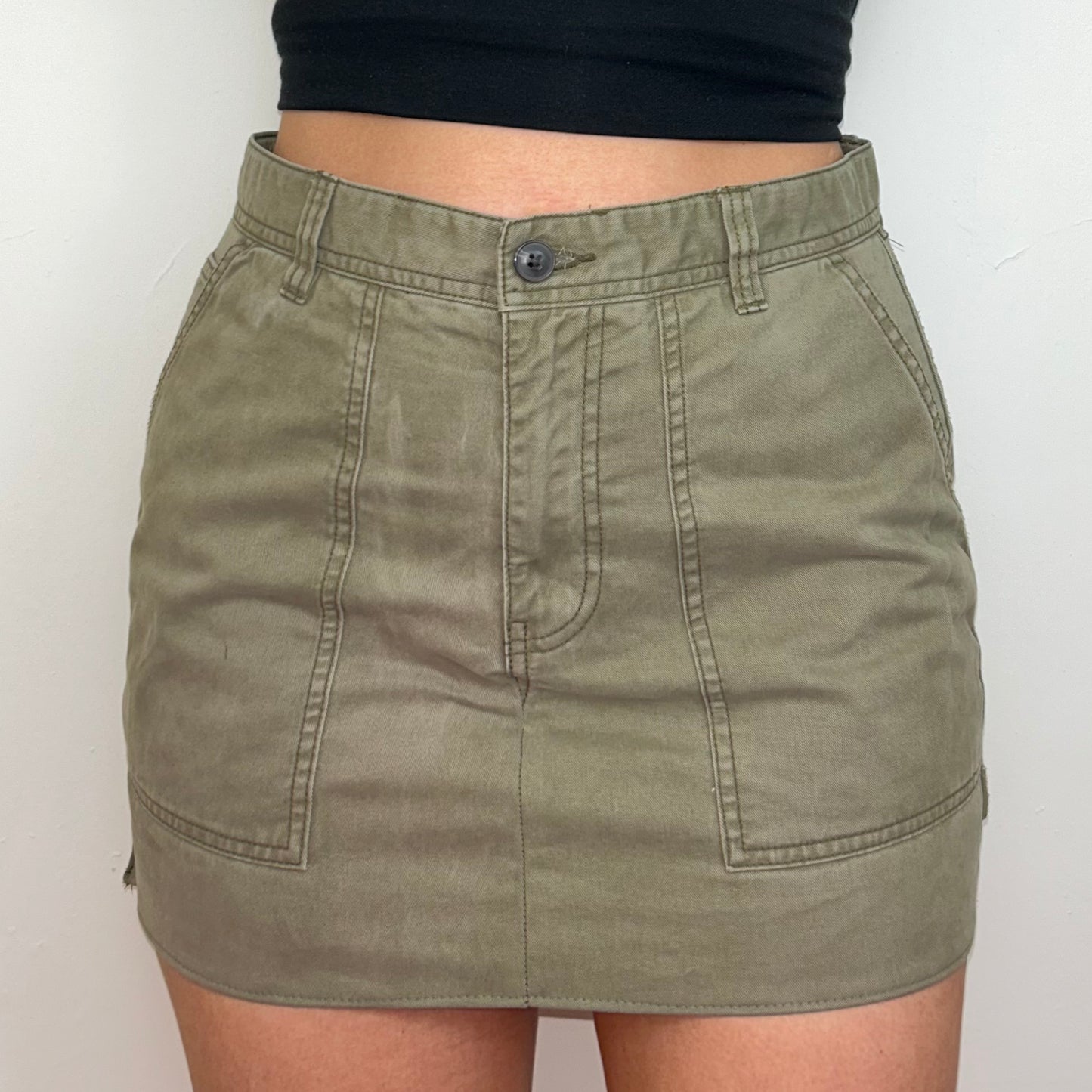 close up of beige cargo mini skirt shown on a model